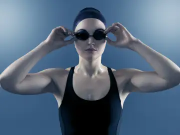Woman underwater wearing swimming goggles