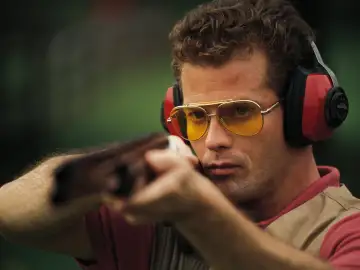 Man holding an air rifle wearing shooting glasses