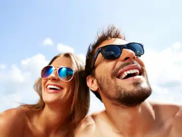 Man and Woman smiling wearing sunglasses